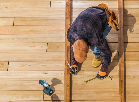 Worker Repairing An Existing Deck Build - Hard Decks - Hard Decks Worker Repairing An Existing Deck Build