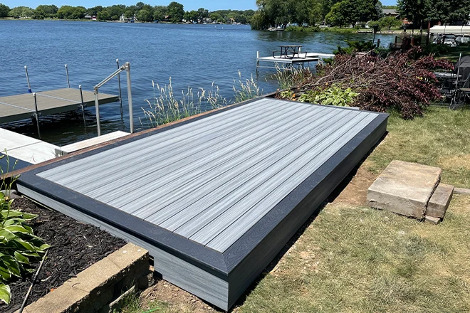 Smaller light gray deck by a lake - Hard Decks Smaller light gray deck by a lake