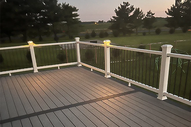 New deck at night with white railing and post lights - Hard Decks New deck at night with white railing and post lights