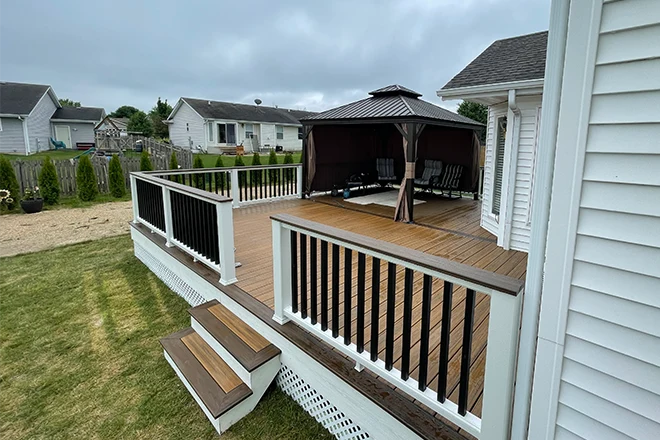 New deck installation made from several deck materials that has a roofed section - Hard Decks New deck installation made from several deck materials that has a roofed section