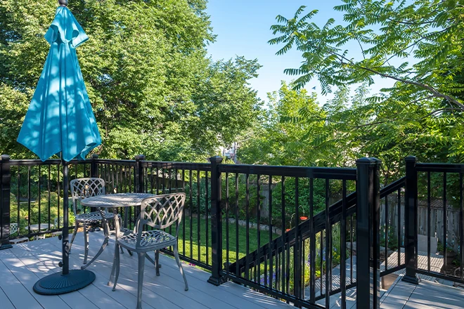 Decking Material Options That'll Make Your Deck the Talk of Your Neighborhood 5 Gray PVC Deck with Black Metal Railing