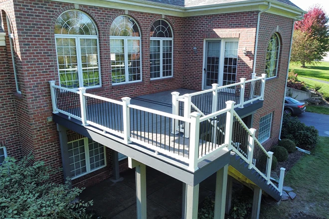 What Is Composite Decking & Should Belvidere, IL, Homeowners Use It? 6 Upper level gray composite decking with white railing