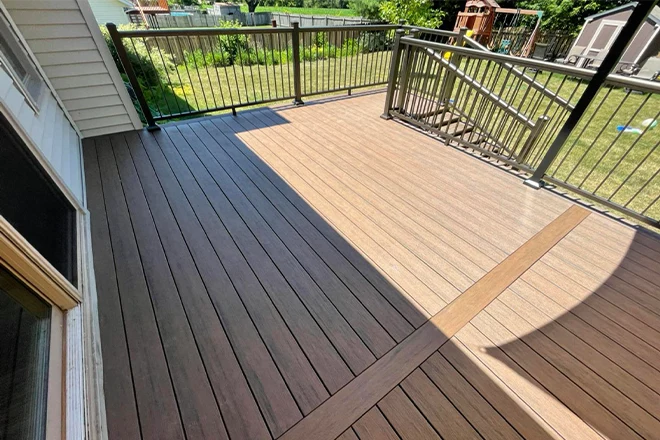 7 Benefits Of Composite Decking For Belvidere Homeowners 3 Beautiful brown composite deck with stairs and railing