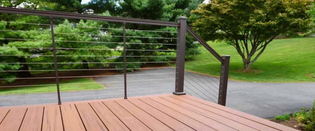 a composite deck featuring a modern horizontal cable railing system