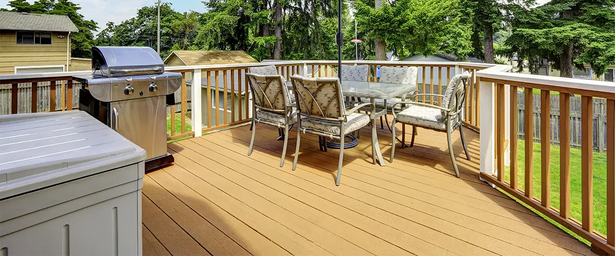 Outdoor deck with grill and glass patio table set
