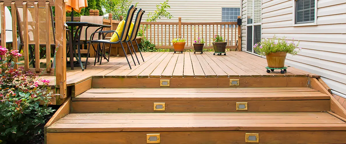 Deck Replacement in Rockford, IL 8 Backyard deck with steps and potted plants