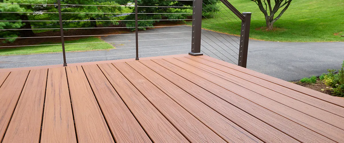 Deck Building in Rockton, IL 8 Composite deck with metal railing overlooking driveway and lawn