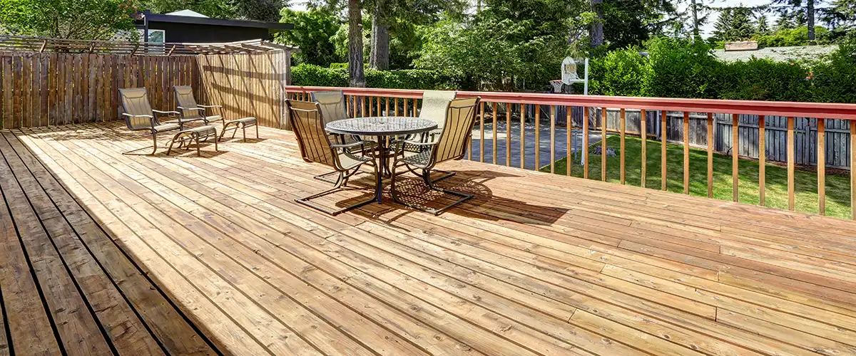 Spacious deck with table and chairs overlooking yard