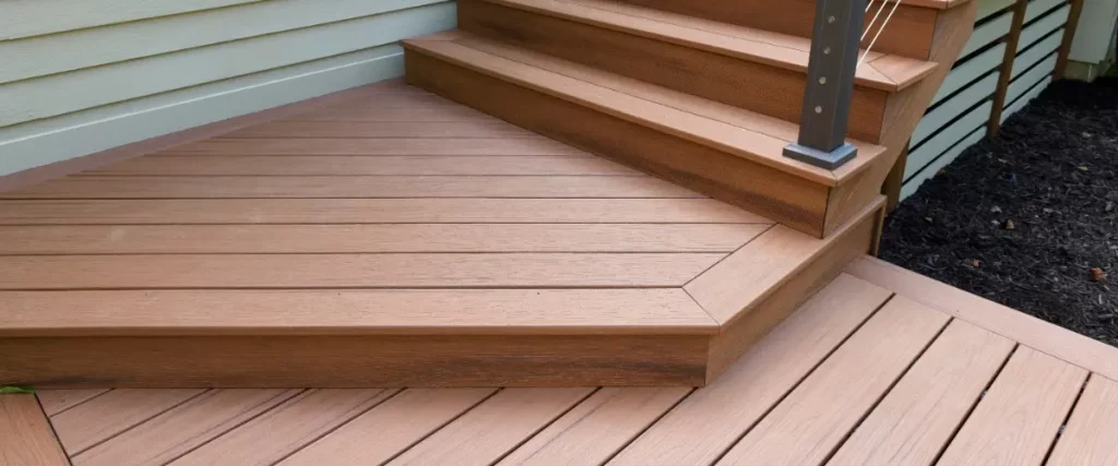 A composite deck featuring stairs and a railing, providing a sturdy outdoor space for relaxation or gatherings.