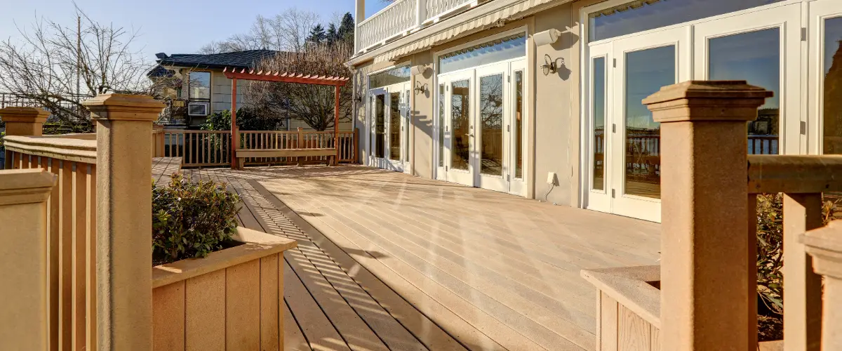 A composite deck featuring a light-colored, wood-look surface, resistant to rot and decay