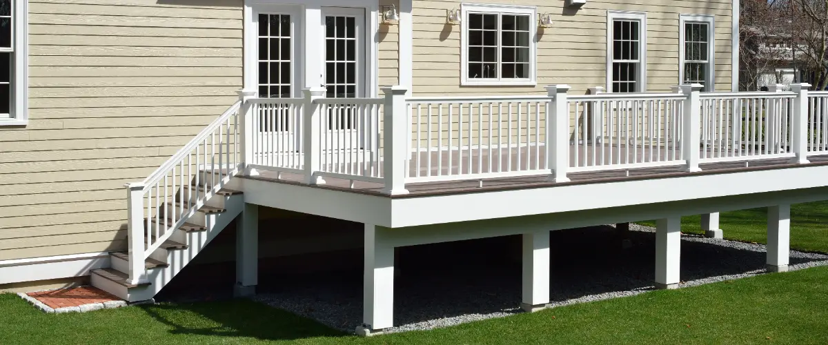 an elevated deck attached to the back of a house